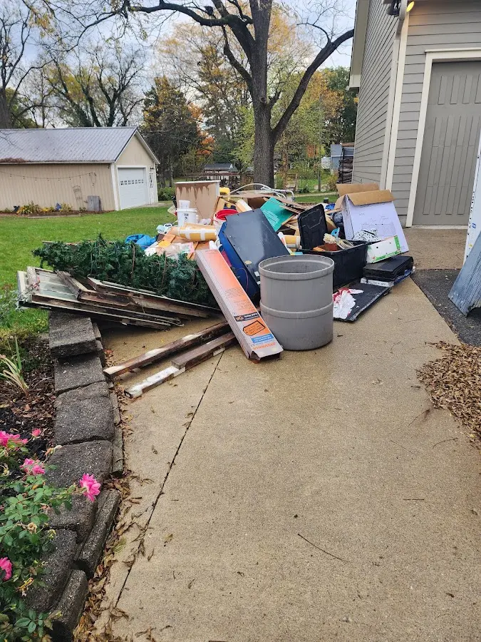 Dumpster being loaded with debris for Commercial Dumpster Rental in Parkville